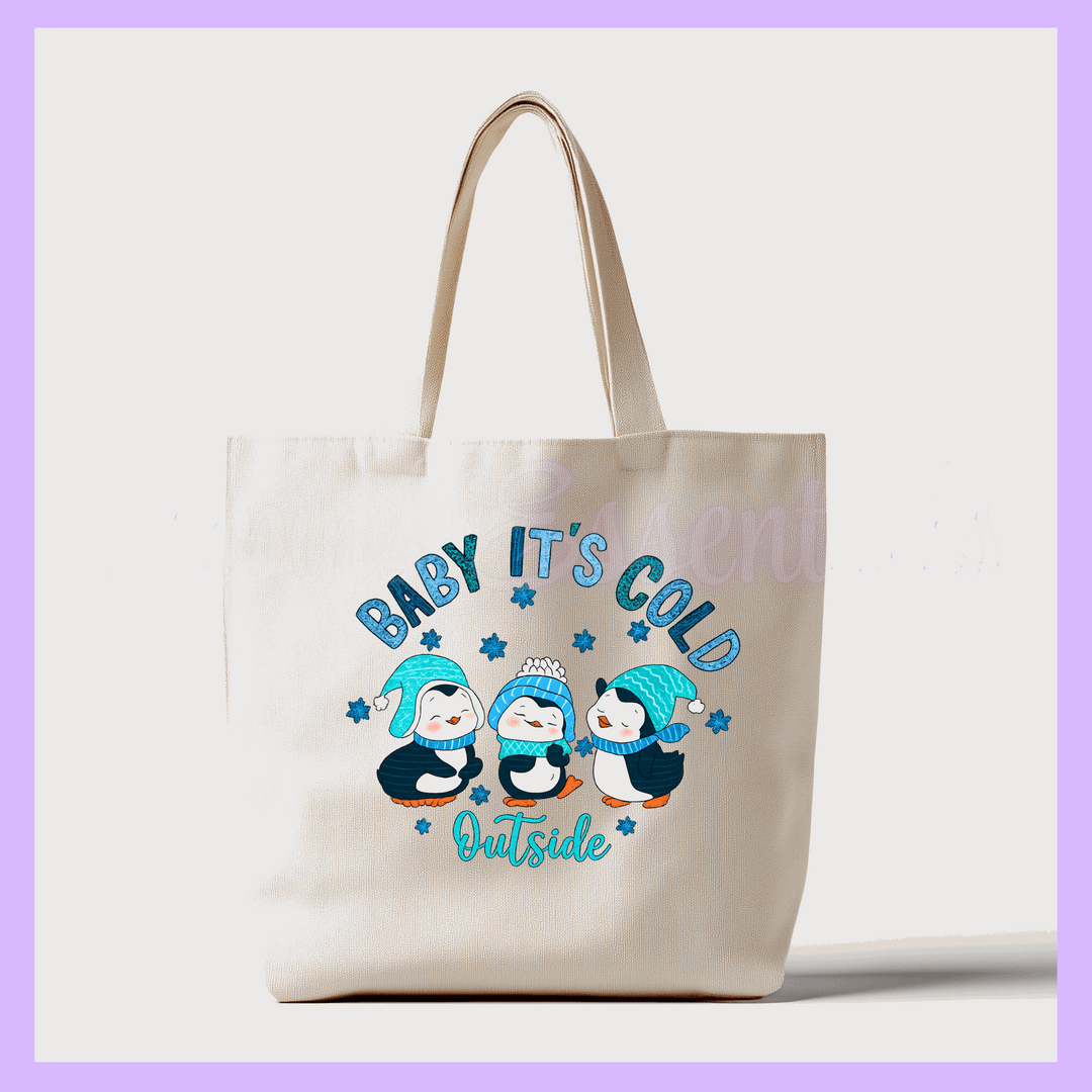 Tote bag with penguin design and text 'Baby, It's Cold Outside' 