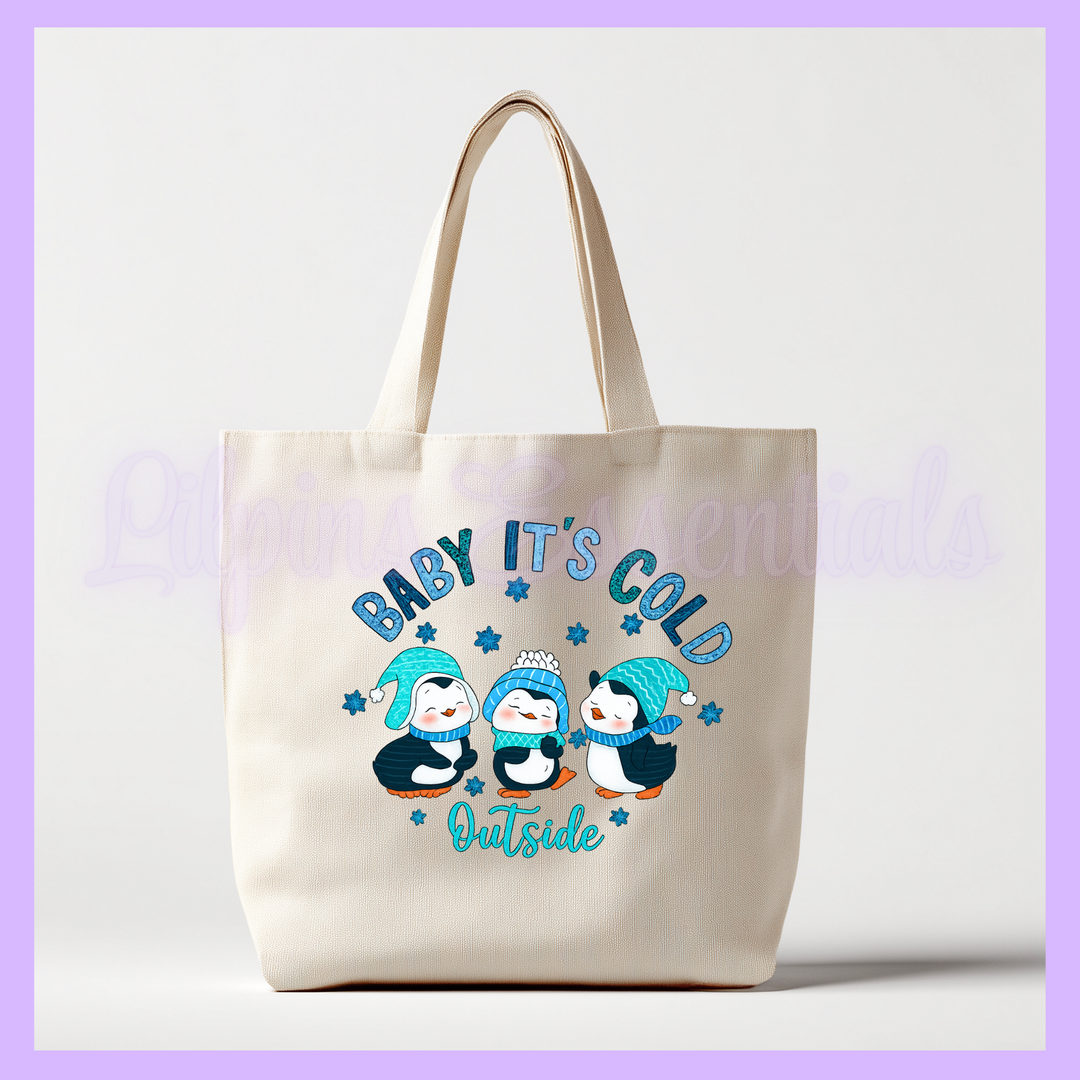 Tote bag with penguin design and text 'Baby, It's Cold Outside' 