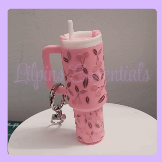 Pink water bottle-shaped keychain with floral design 