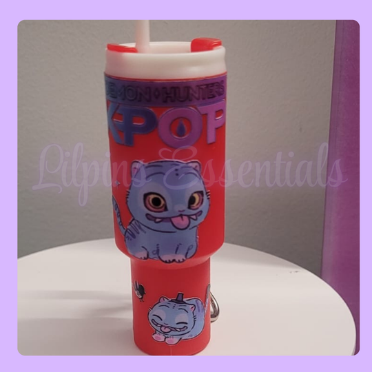 Red tumbler with a kpop design and 'Monsters, Inc.' text on a white surface.