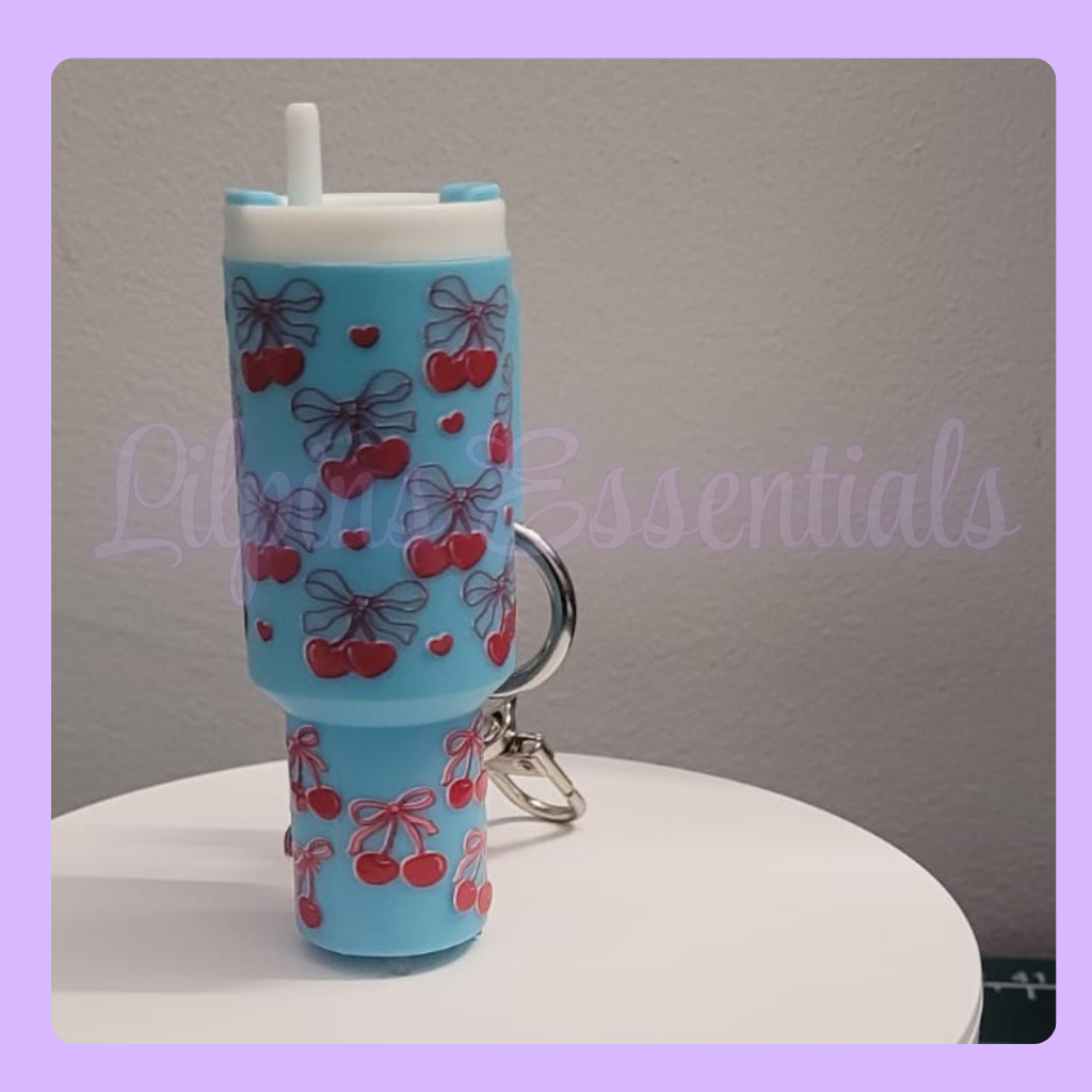 Blue lip balm keychain with cherry and bow design 