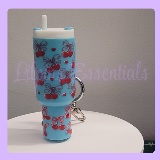 Blue lip balm keychain with cherry and bow design 
