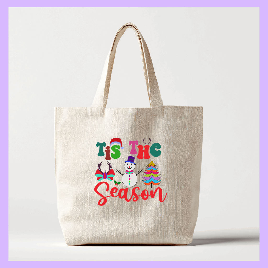 Beige tote bag with 'Tis the Season' text and Christmas graphics 