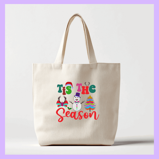 Beige tote bag with 'Tis the Season' text and Christmas graphics 
