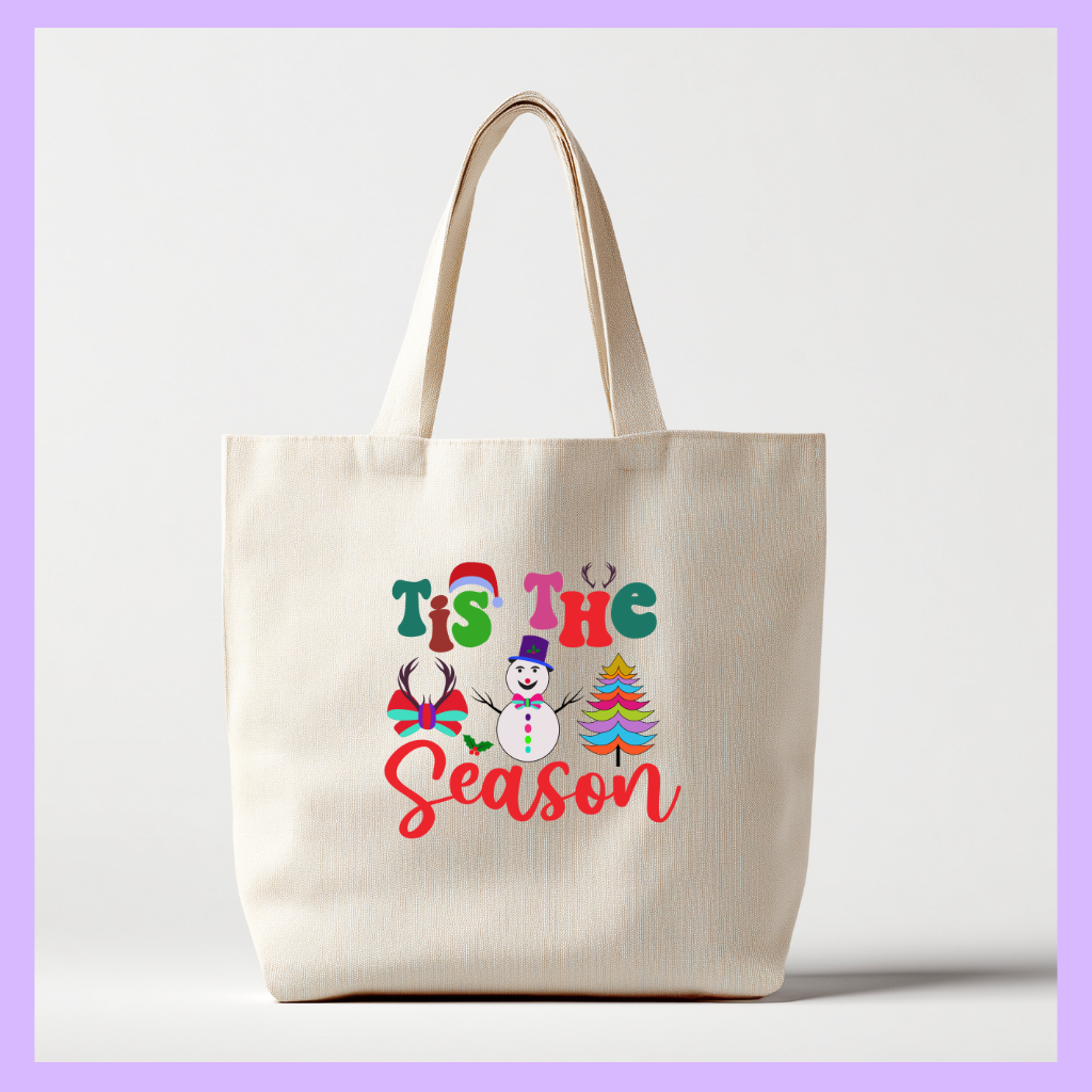 Beige tote bag with 'Tis the Season' text and Christmas graphics 