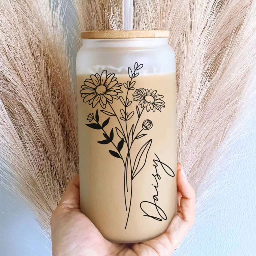 A tumbler with floral design and &
