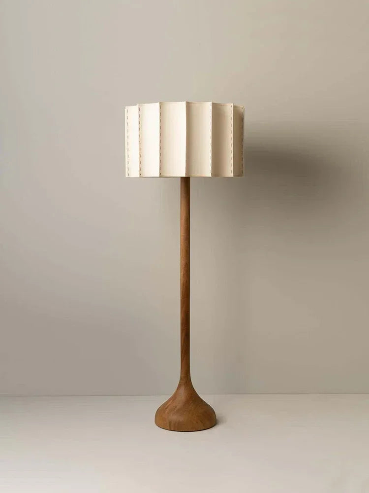a wooden lamp with a white shade on it