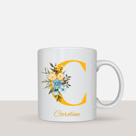 Personalised floral name mug shown in a styled lifestyle setting