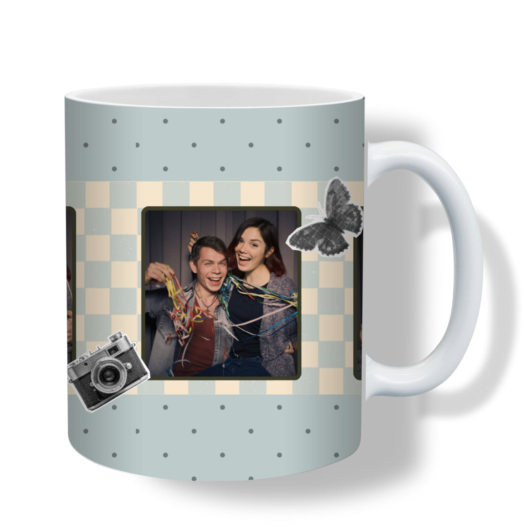 Close-up of personalised photo booth mug with three photos, dusty-blue checkerboard strip, camera and butterfly details