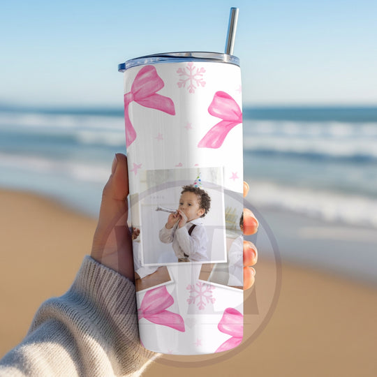 Personalised pink bow and snowflake photo tumbler held outdoors
