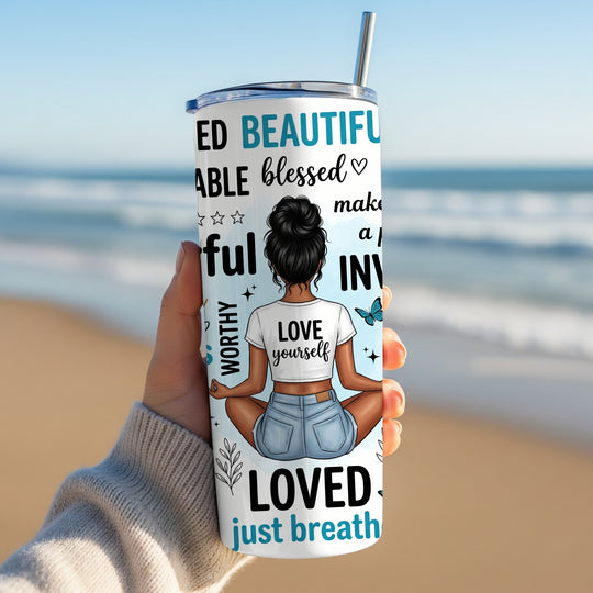 Woman holding self love affirmation tumbler on beach